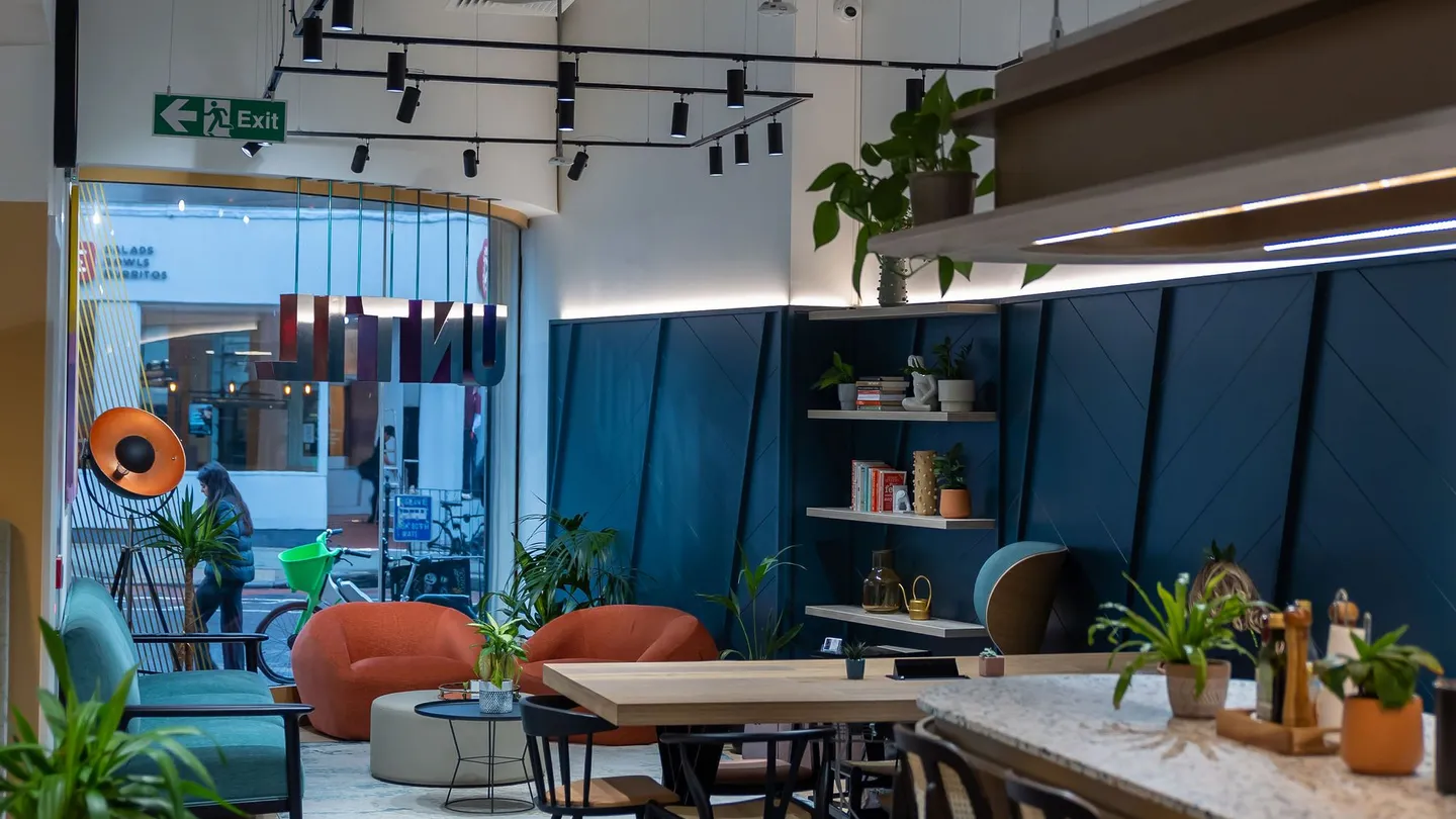The club social space at UNTIL Soho, with tables and lounge seating