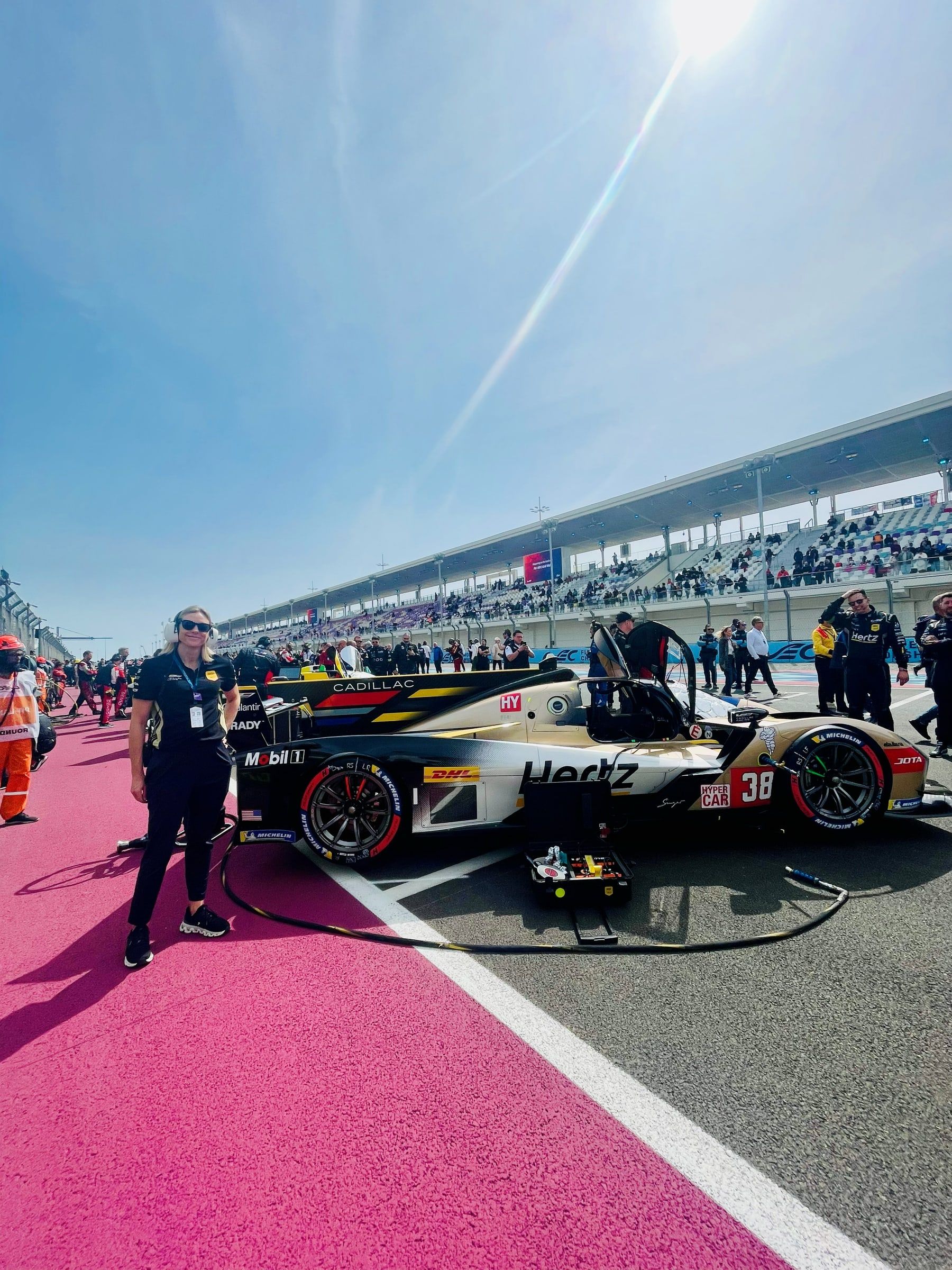 Carly Christensen on the grid beside the Cadillac Hertz Team Jota car in Qatar, 2025