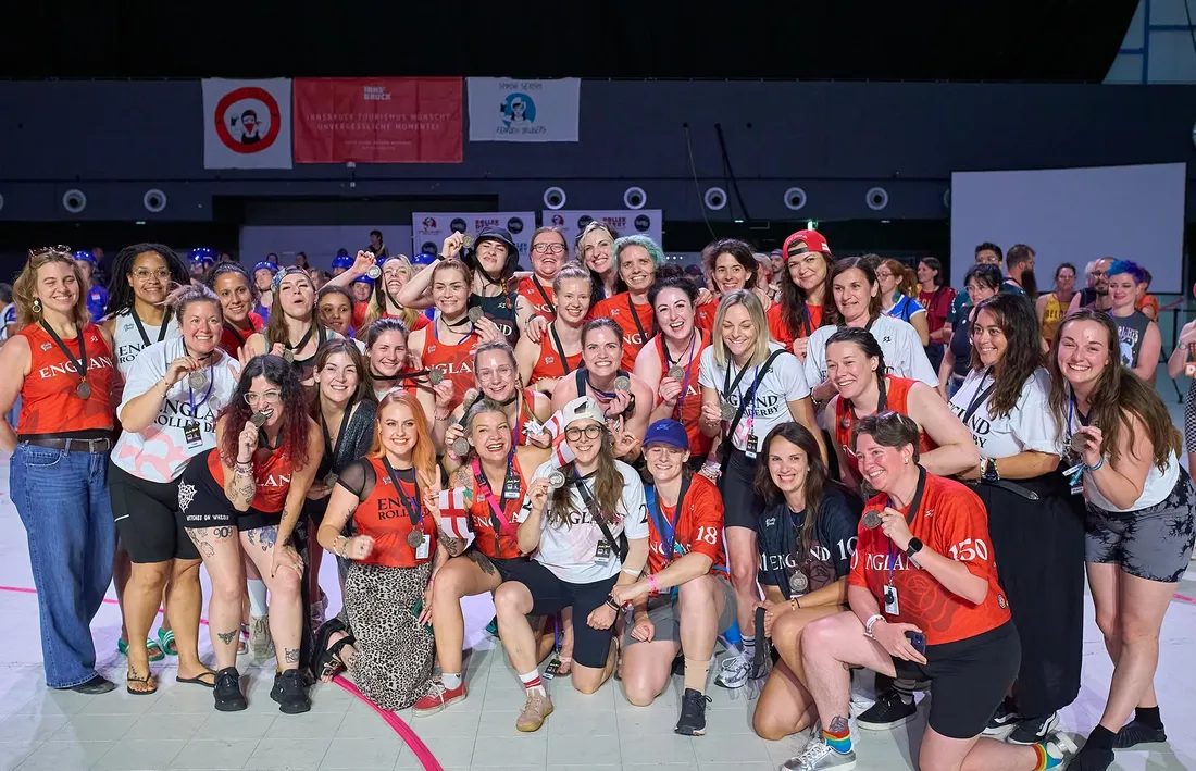 England Women's Roller Derby squad and staff with their medals at the 2025 World Cup in Innsbruck