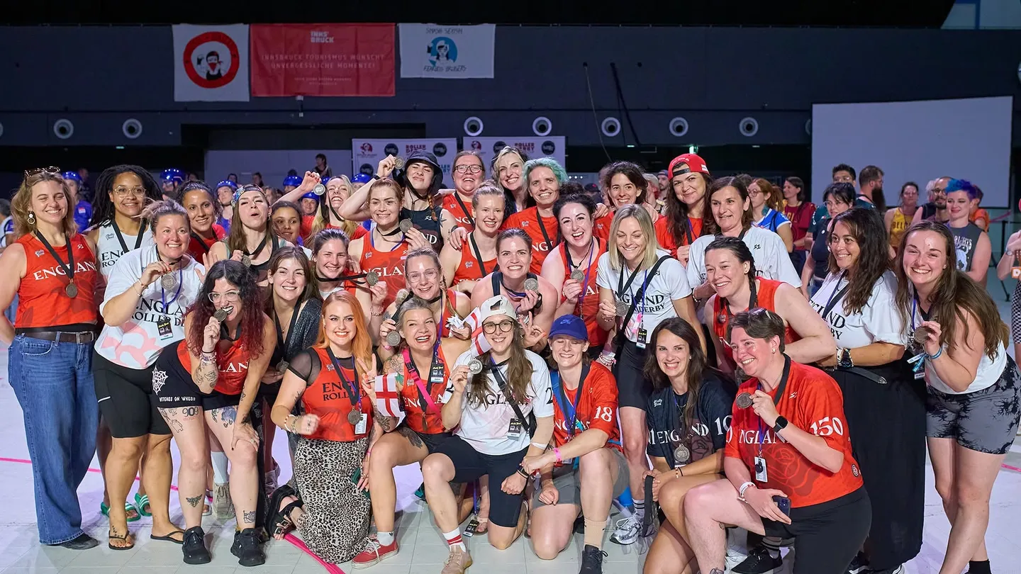 England Women's Roller Derby squad and staff with their medals at the 2025 World Cup in Innsbruck