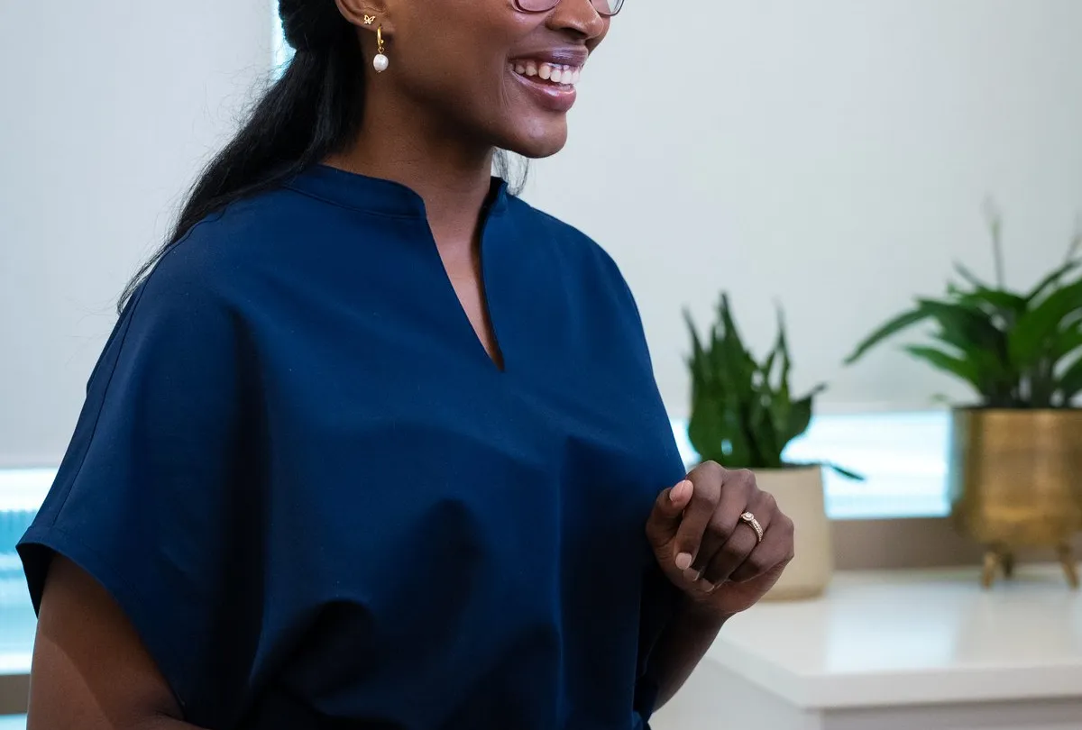Osteopath Lolitaire standing and smiling in a treatment room