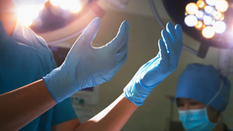 HCPC-registered podiatrist performing nail surgery on a patient's toe under local anaesthetic at a Canary Wharf, London clinic