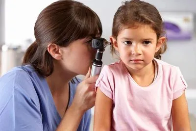 Audiologist carrying out a diagnostic hearing assessment in a London clinic room