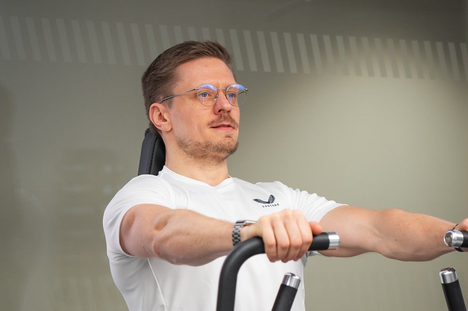 Eugene Churkin training on a seated chest press at UNTIL Canary Wharf