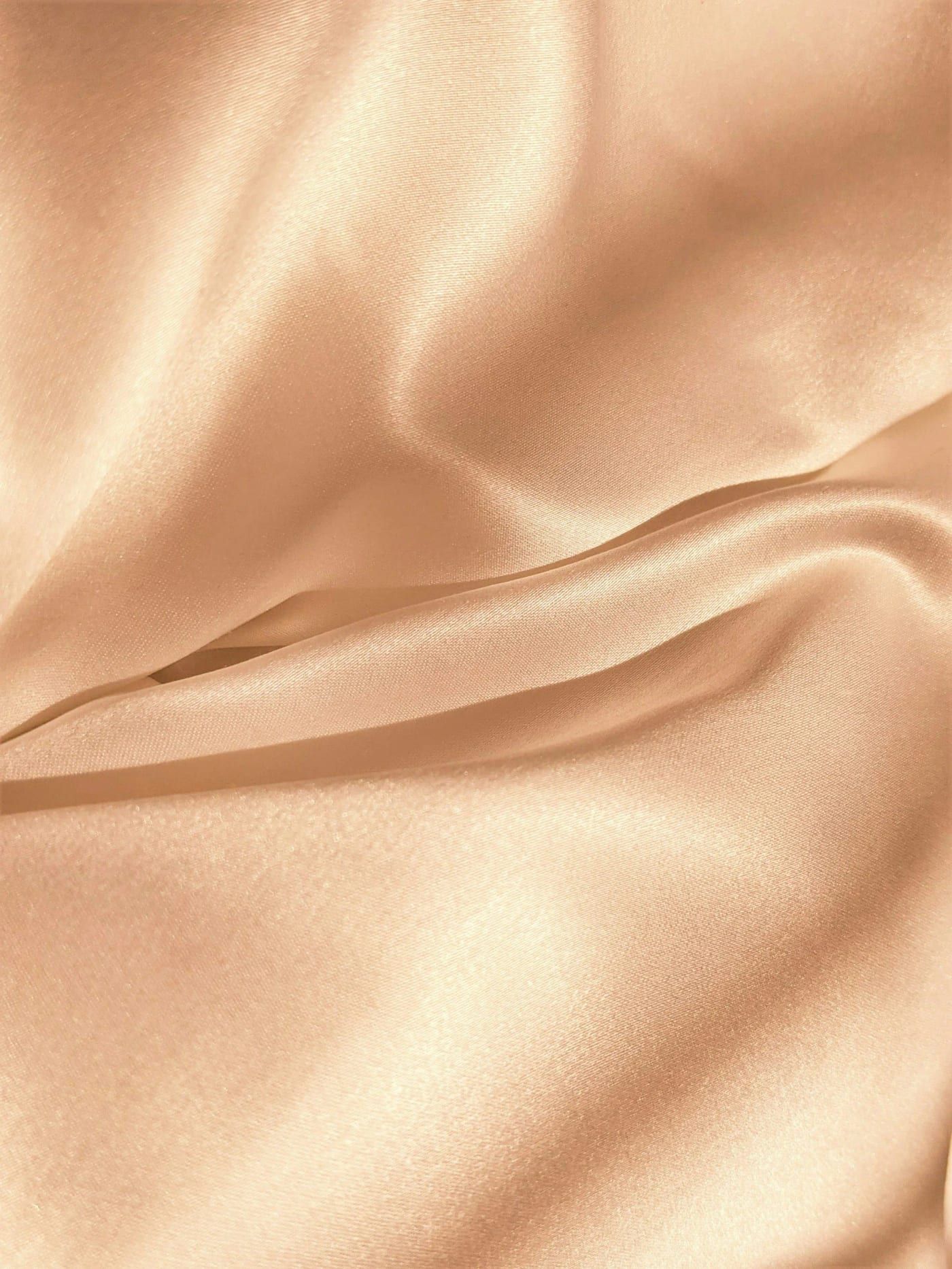 Soft folds of peach-toned silk
