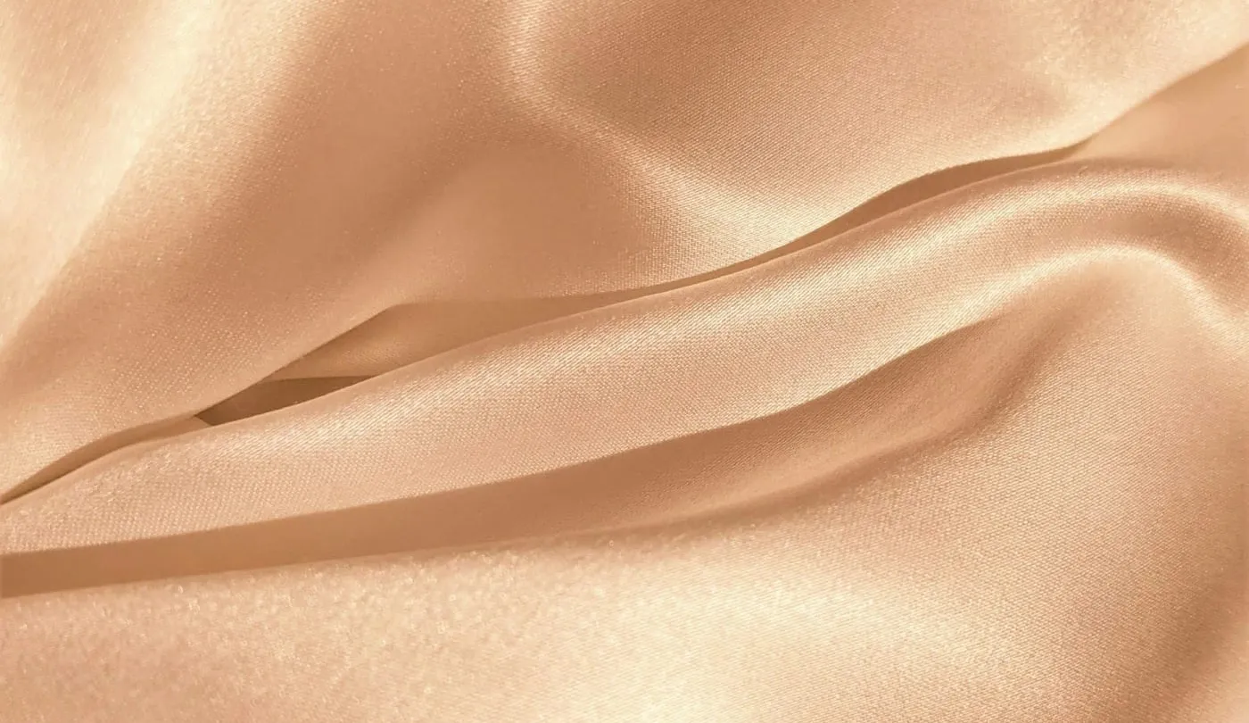 Soft folds of peach-toned silk
