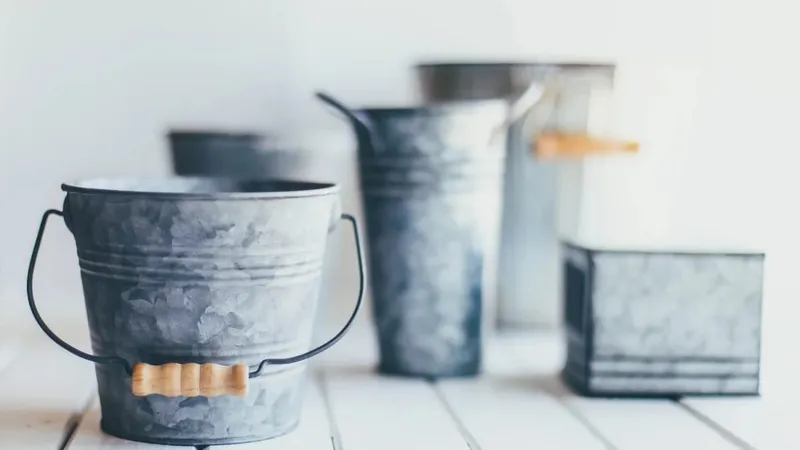 Galvanised metal buckets on a white table, the injury bucket analogy