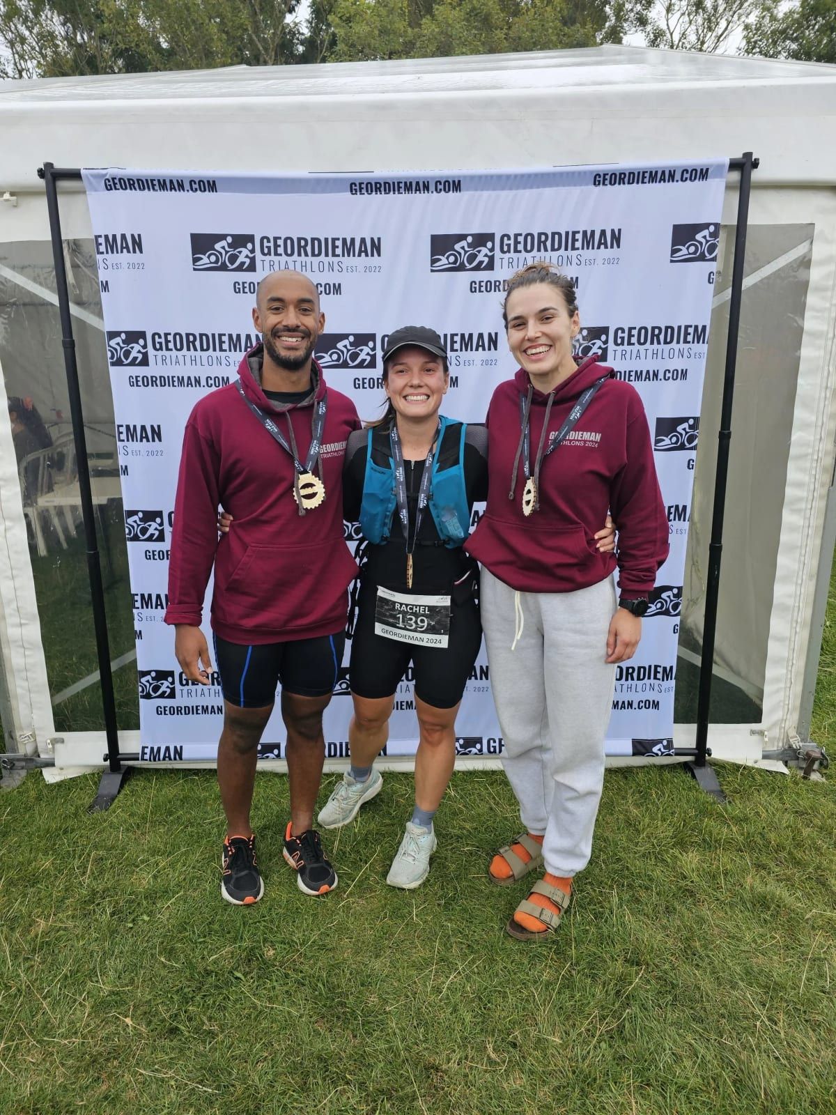 Three finishers with medals at the Geordieman triathlon