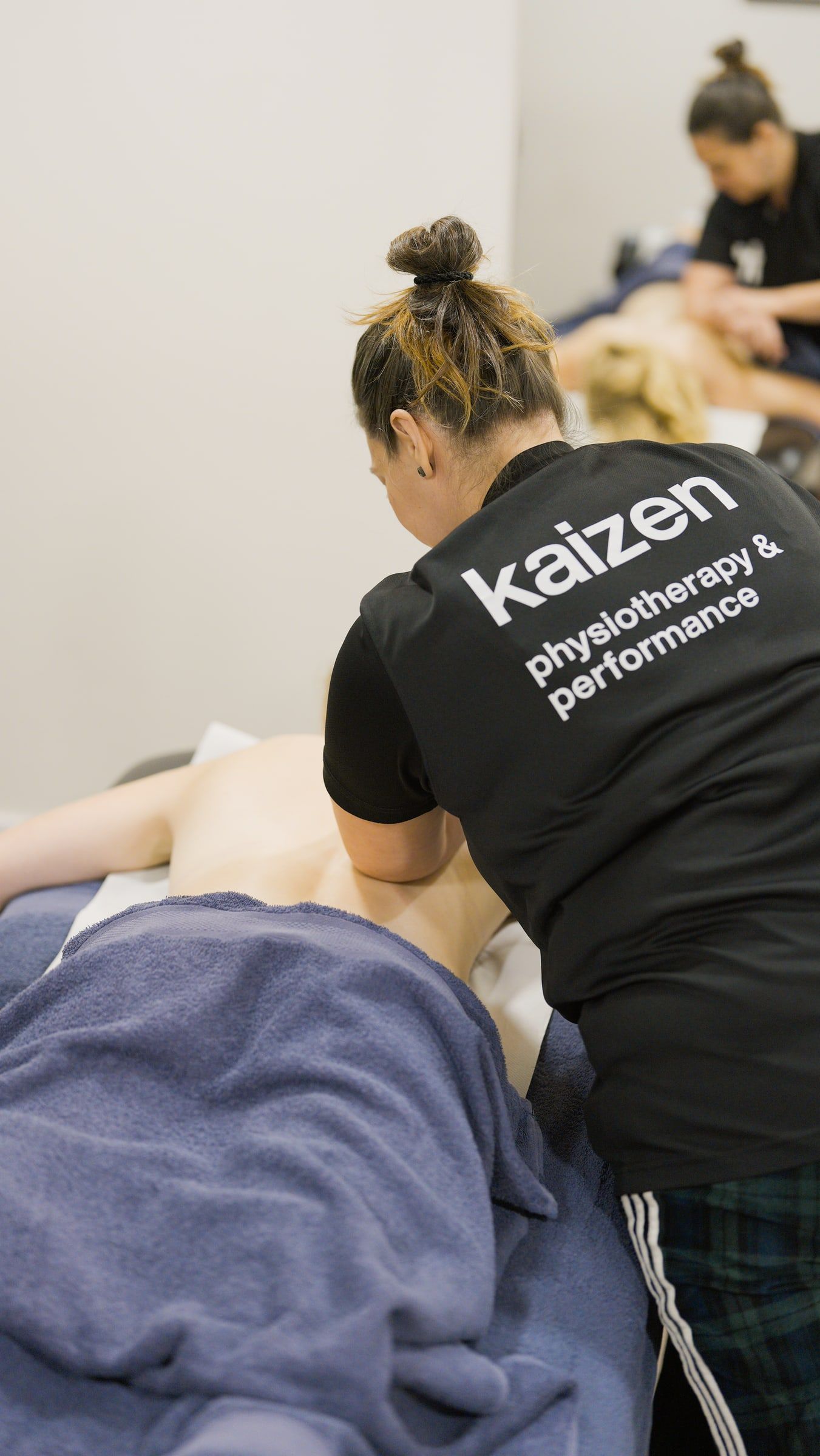 Massage therapist treating a client at Kaizen Physiotherapy & Performance