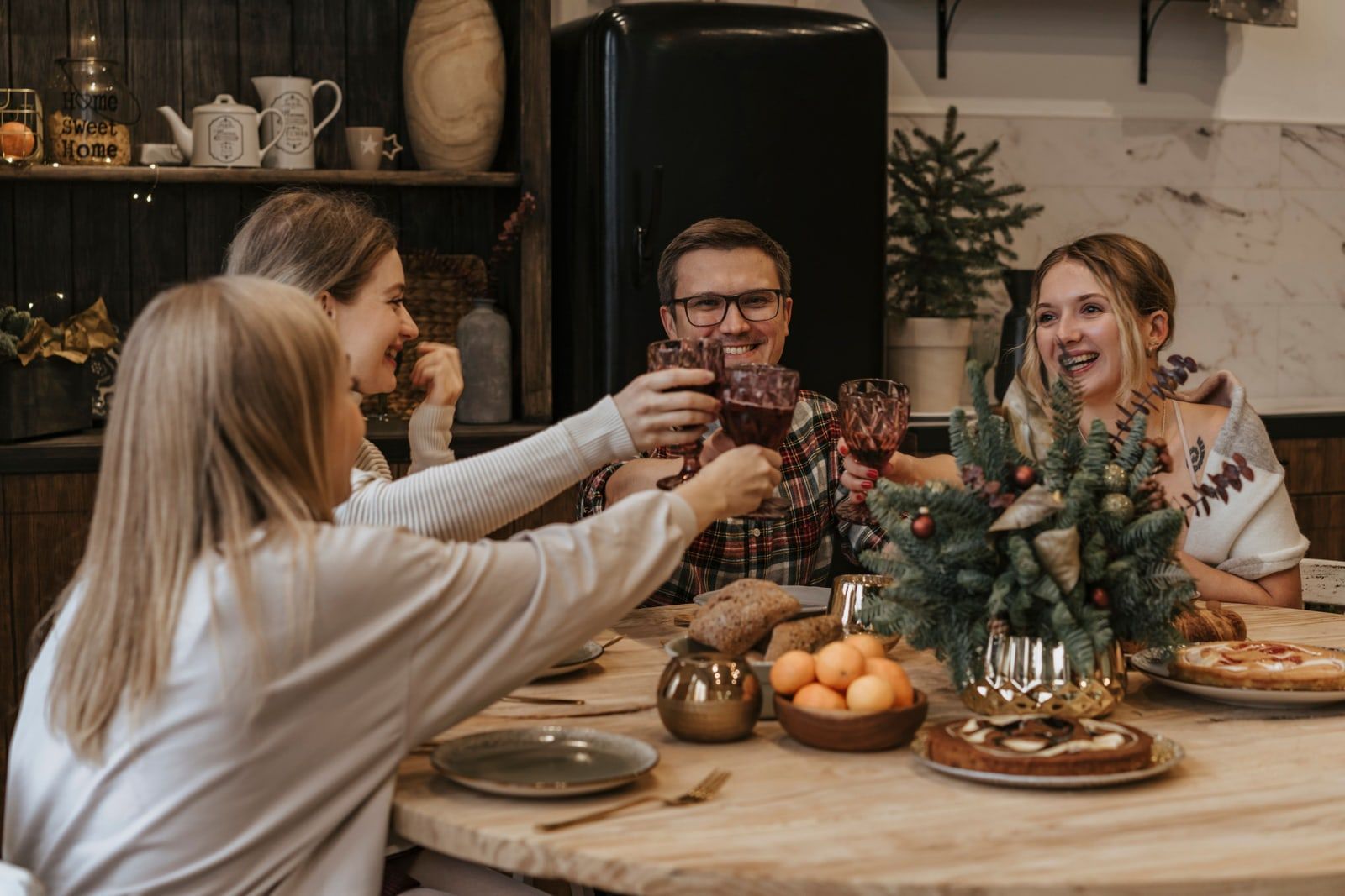 Friends raising a toast at a Christmas dinner table