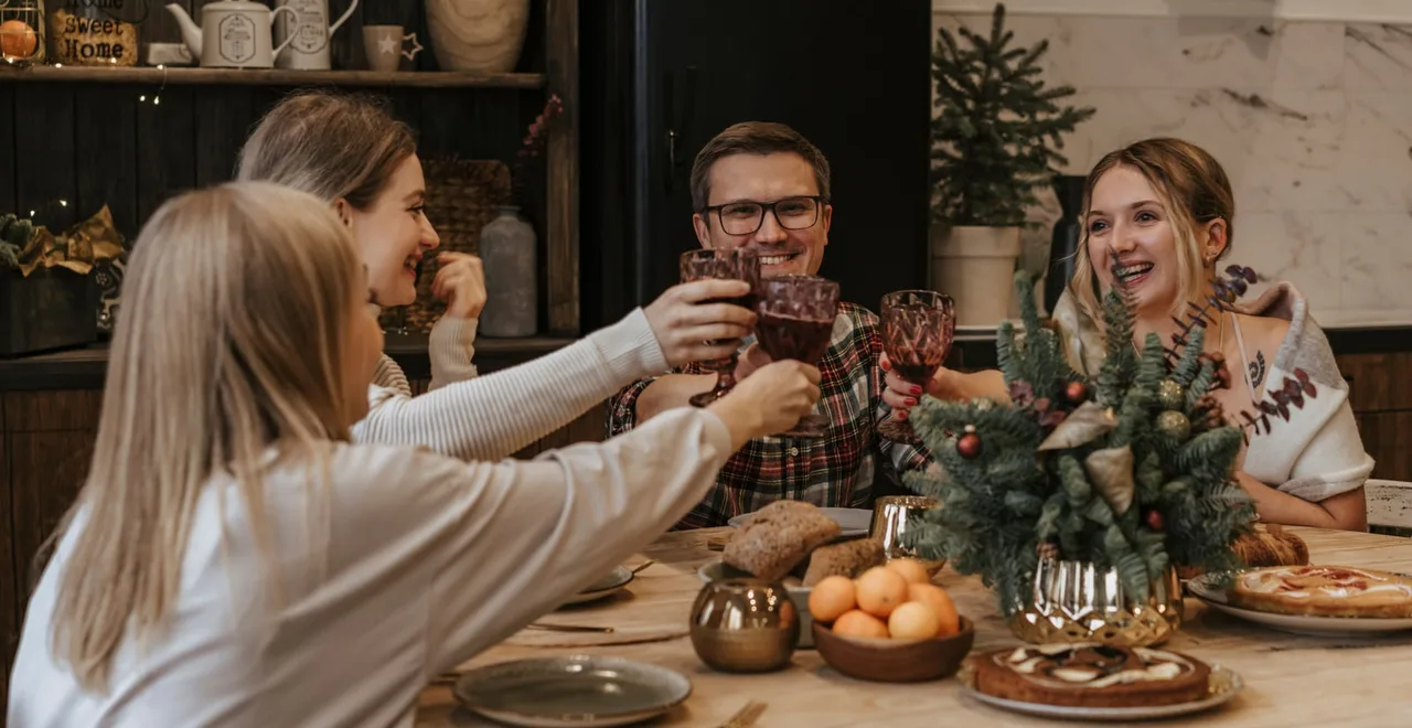 Friends raising a toast at a Christmas dinner table