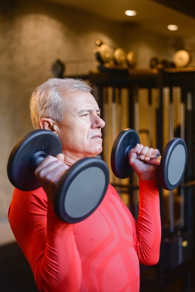 Man training with dumbbells — building muscle after 40