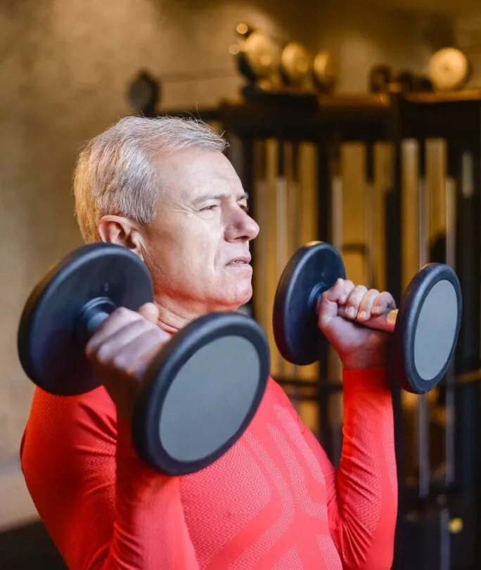Man training with dumbbells — building muscle after 40
