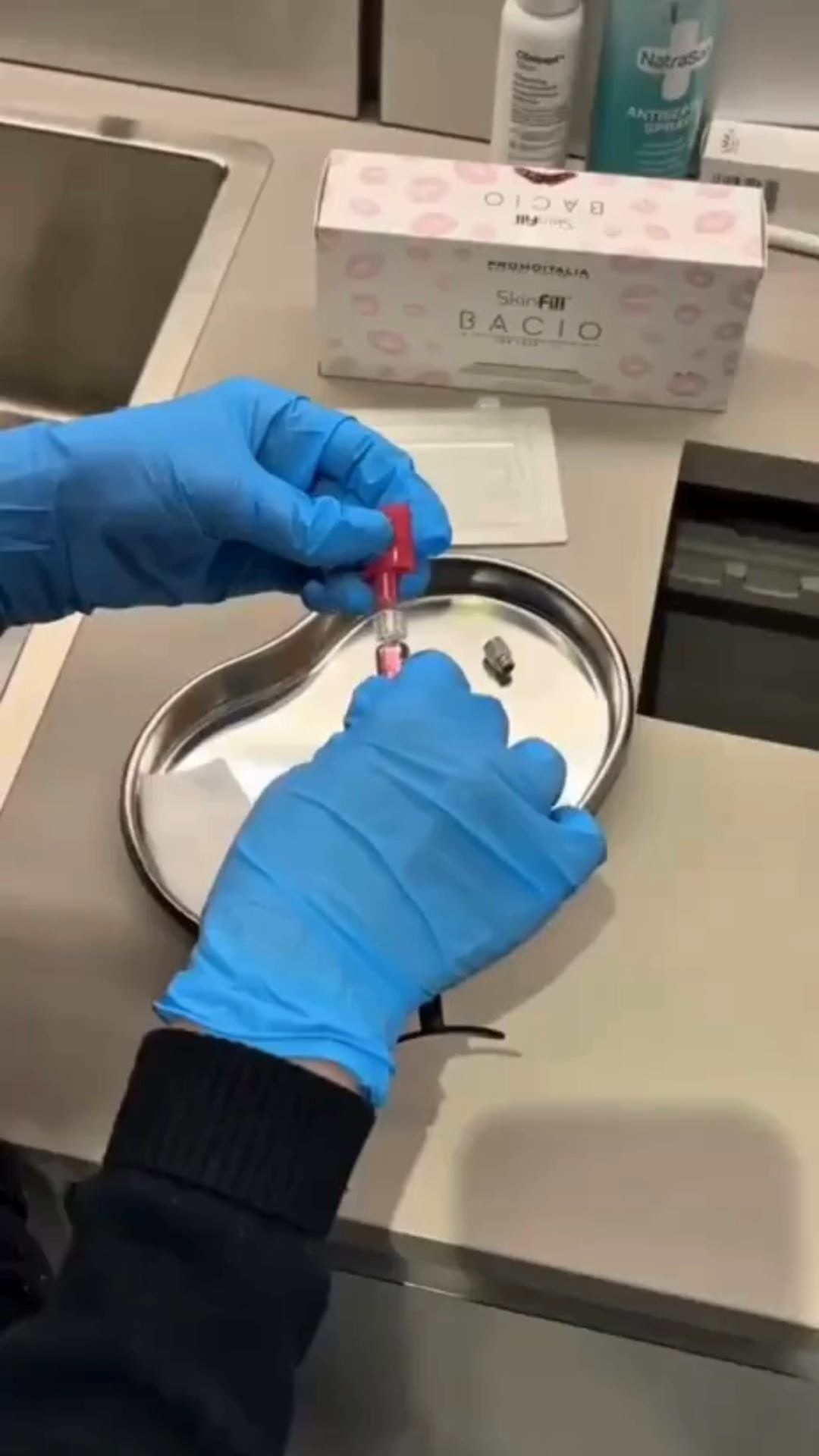 Gloved hands preparing an injectable treatment at Novaderma Aesthetics
