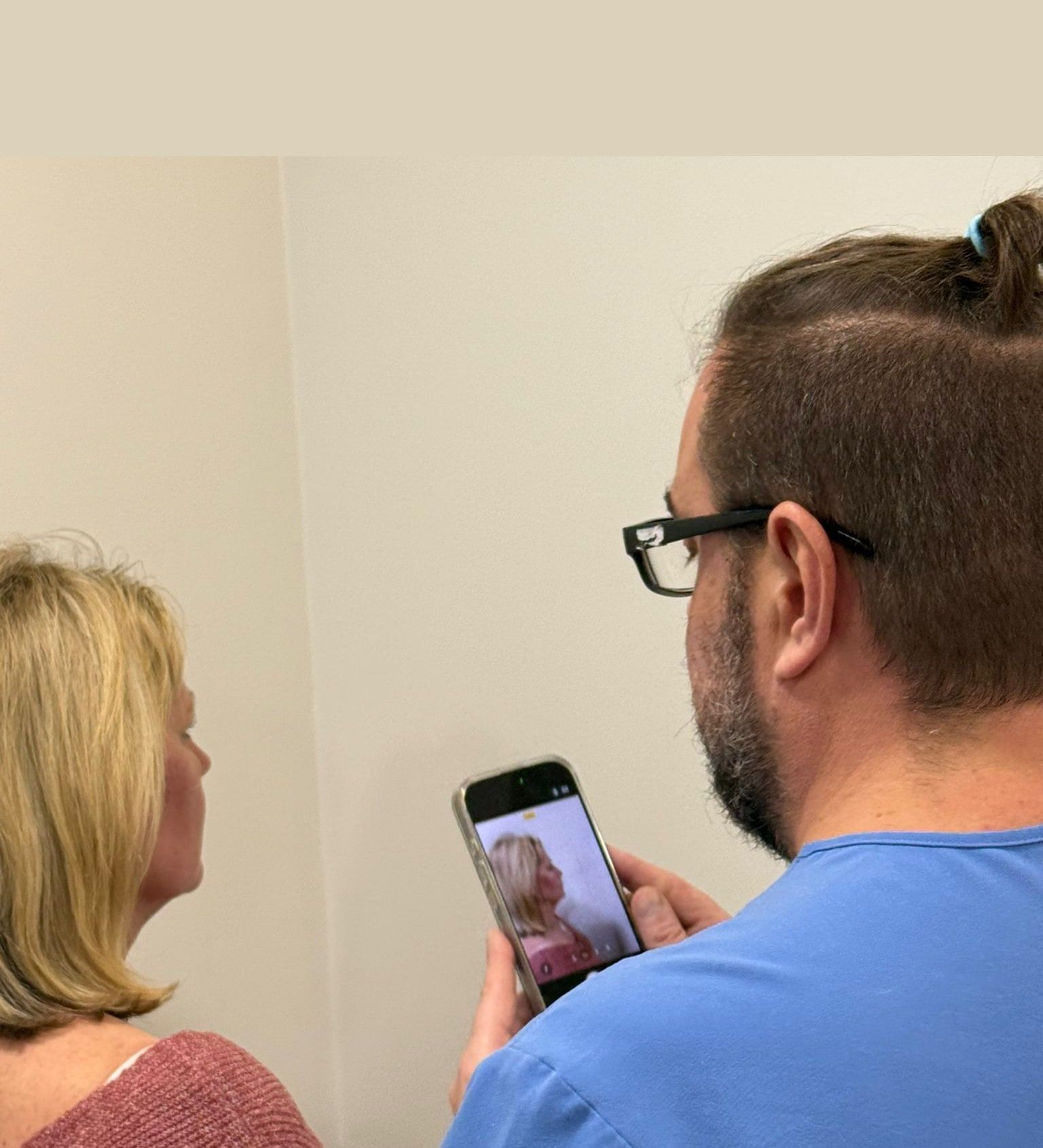 Aesthetic Nurse Practitioner Arek Bulanda reviewing skin photographs with a patient at Perfectus Derma Aesthetics, UNTIL Soho