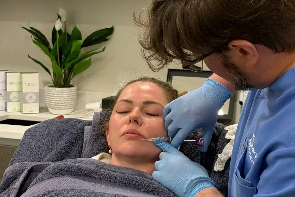 Aesthetic Nurse Practitioner placing dermal filler in a patient's mid face at Perfectus Derma Aesthetics, UNTIL Soho
