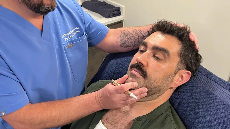 Aesthetic Nurse Practitioner Arek Bulanda assessing a patient before anti-wrinkle treatment at Perfectus Derma Aesthetics, UNTIL Soho