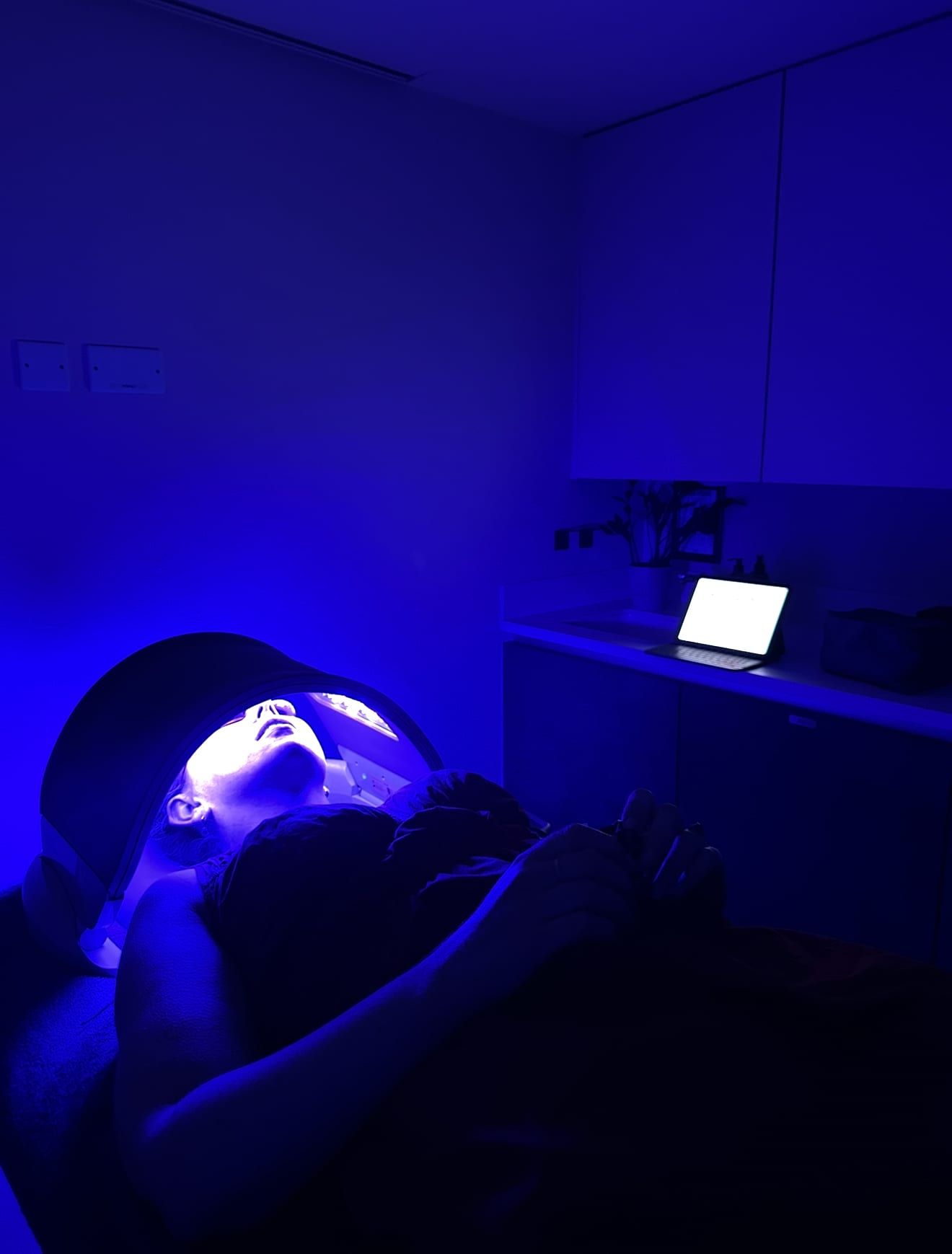Patient receiving blue LED light therapy at Perfectus Derma Aesthetics, UNTIL Soho