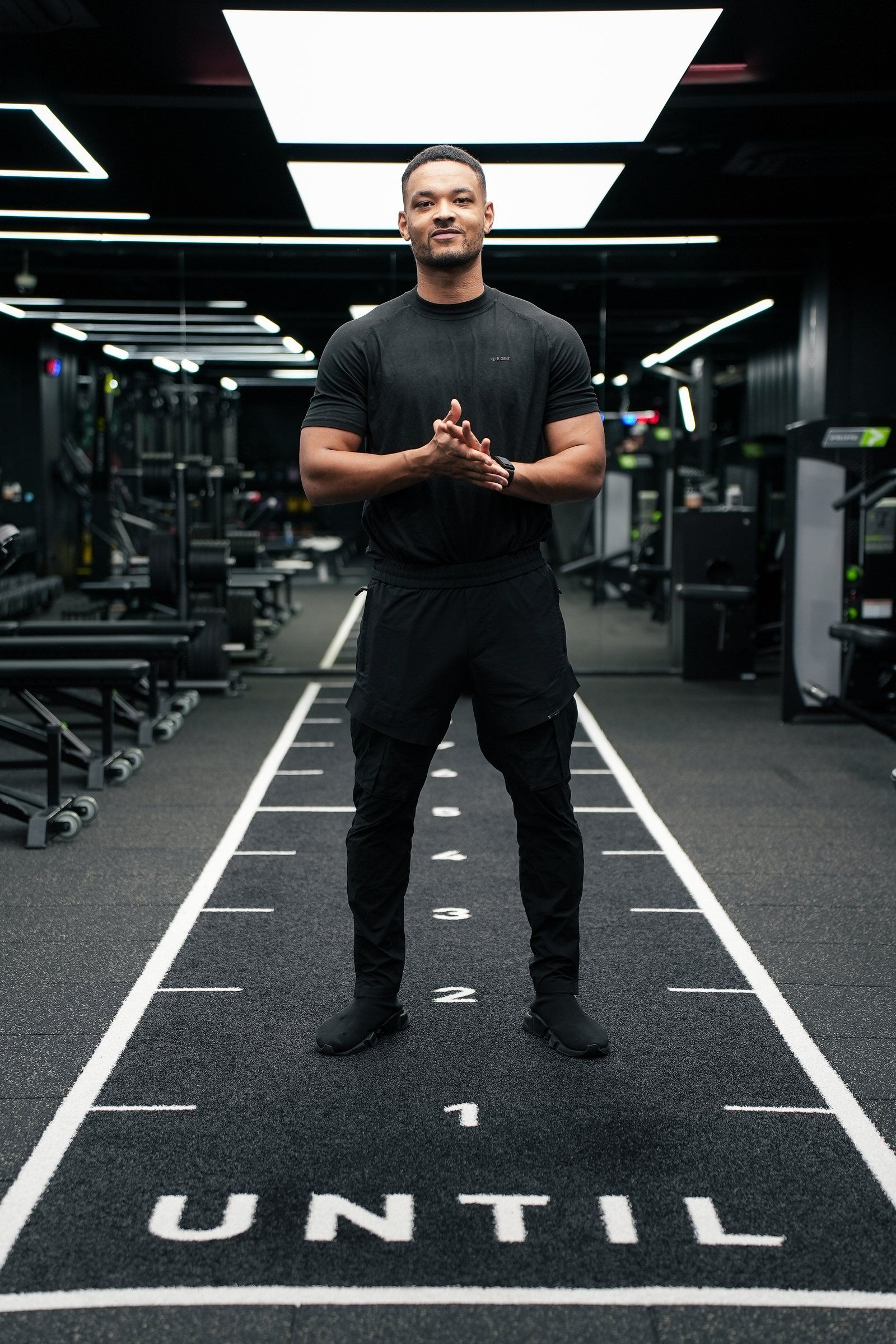 Steven Bartlett standing on the marked training lane at UNTIL with his hands together