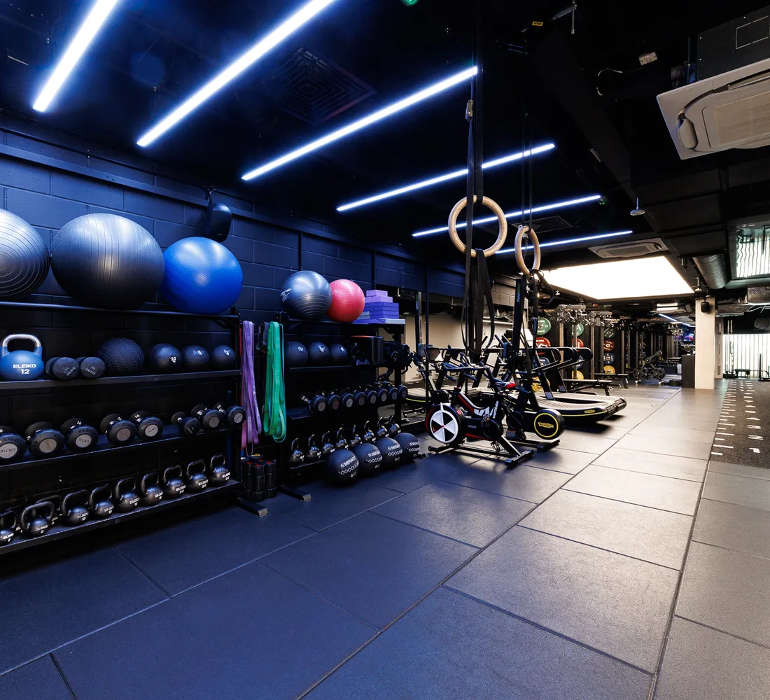 The functional training corner at UNTIL Soho, with stability balls, kettlebells, bands and gymnastic rings