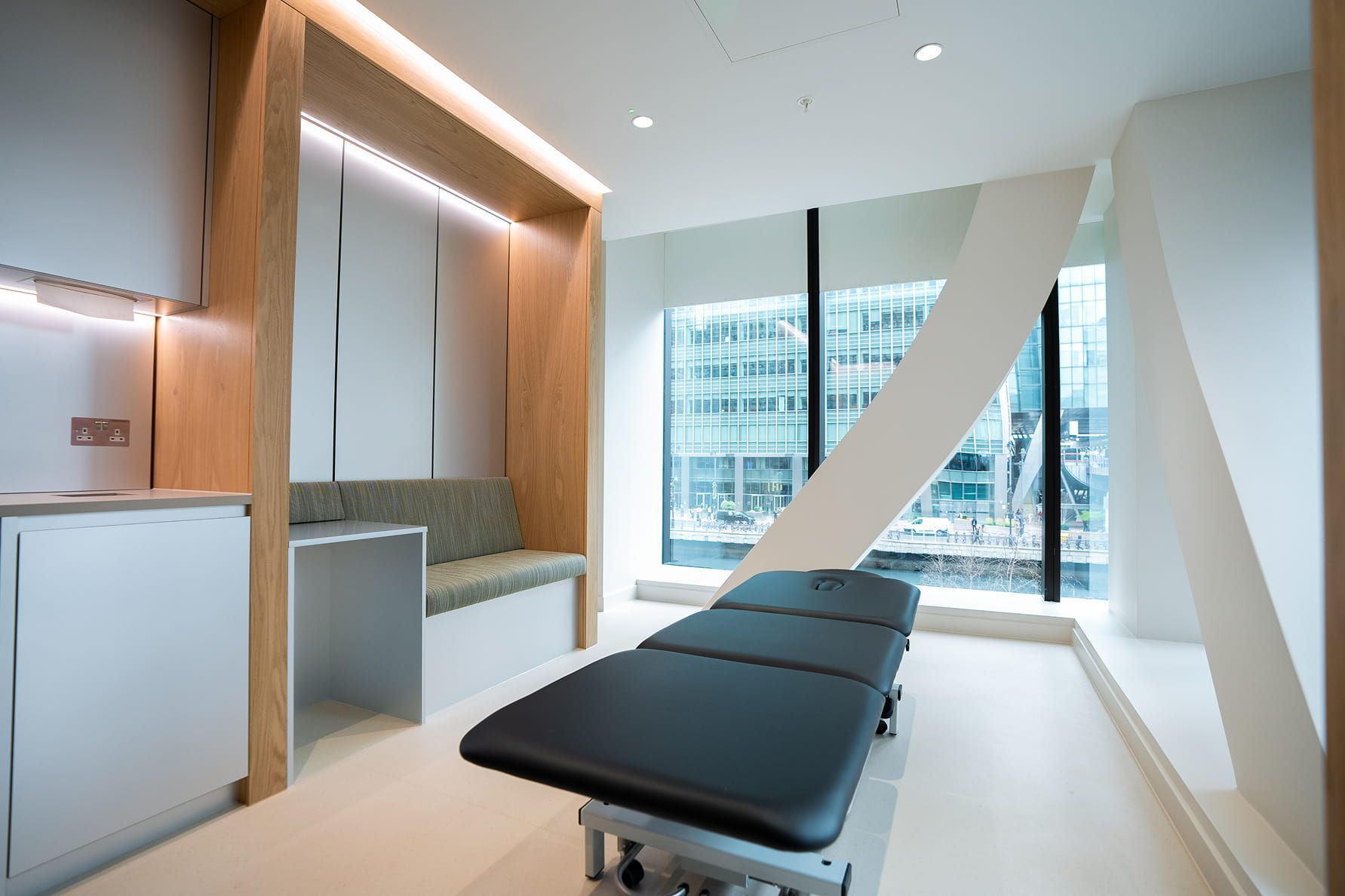 Treatment room at UNTIL Canary Wharf: a clinical plinth set up for assessment and hands-on treatment.