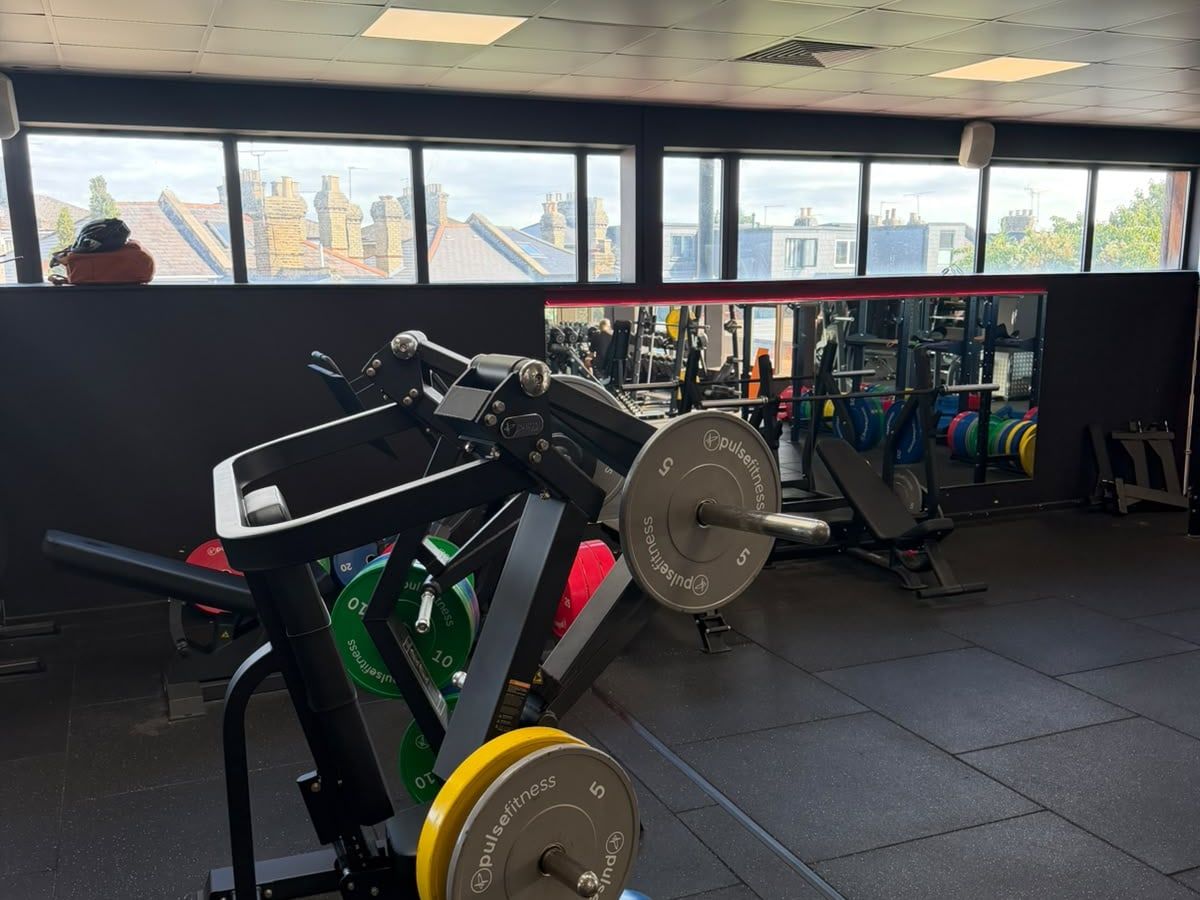 Plate-loaded resistance machines under the gym windows at the Crouch End clinic.