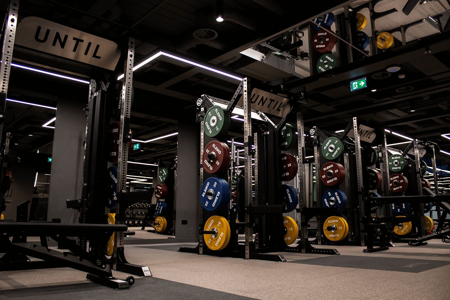 The gym floor at UNTIL Marylebone, with squat racks and Eleiko plates for progressive rehab.