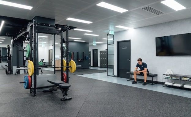 The private training studio at Common Purpose, Mayfair, with a rack, bench and screen