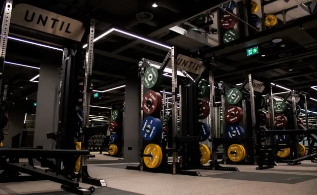 The strength training floor at UNTIL Marylebone, with racks and loaded barbells