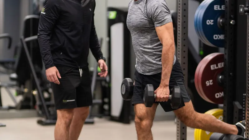 Leigh Clayton coaching a client through a dumbbell lunge at W1 Performance, Marylebone