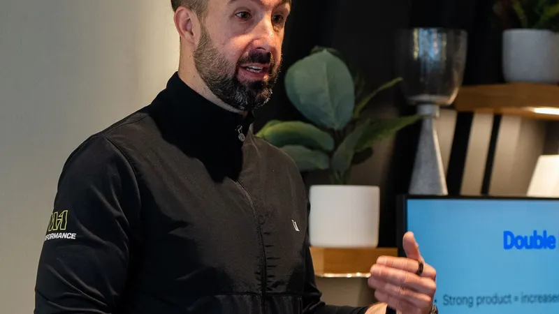 Leigh Clayton of W1 Performance reviewing a client programme on a tablet